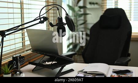 Home studio with laptop and condenser microphone. Entertainment, podcasts and technology concept Stock Photo