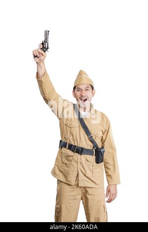 Indonesian freedom fighter standing while holding gun isolated over white background Stock Photo