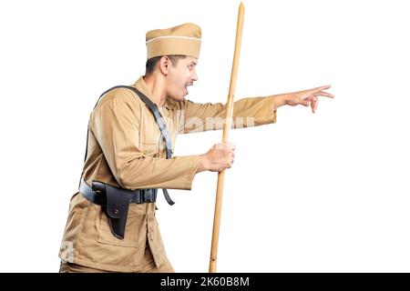 Indonesian freedom fighter standing while holding sharpened bamboo stick isolated over white background Stock Photo