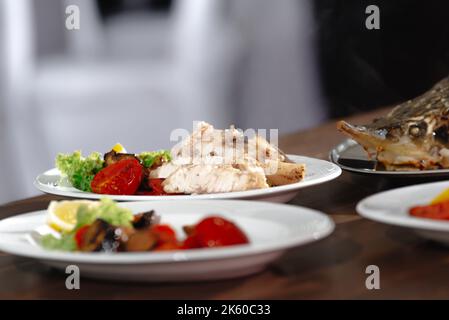 fish slices on plates. Cooked fish sturgeon baked Stock Photo