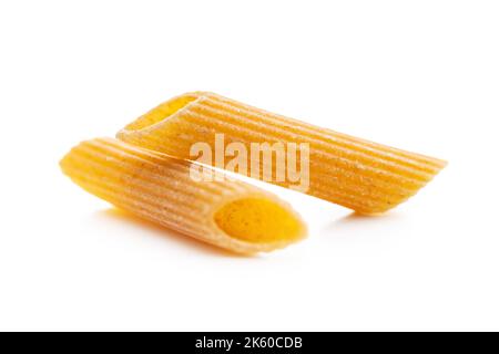 Uncooked whole grain pasta isolated on the white background. Raw penne pasta. Stock Photo