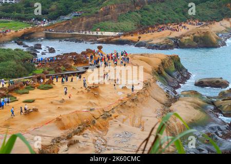 YEHLIU, TAIWAN - NOVEMBER 24, 2018: People visit Yehliu Geopark in Taiwan. Yehliu is a popular tourism destination with peculiar natural rock forms Stock Photo