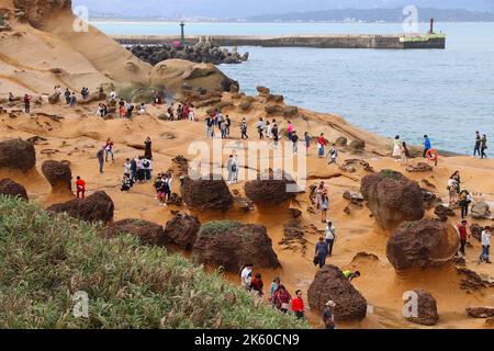 YEHLIU, TAIWAN - NOVEMBER 24, 2018: People visit Yehliu Geopark in Taiwan. Yehliu is a popular tourism destination with peculiar natural rock forms Stock Photo