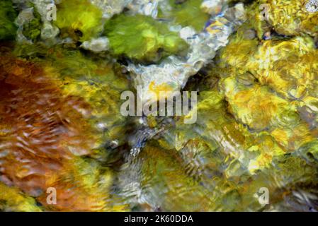 Abstract of refraction and diffraction of light on moving water Stock Photo