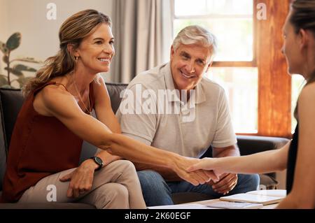 Senior couple, handshake and finance worker welcome, thank you or agreement with consulting with money or retirement savings. Advisor planning funeral Stock Photo