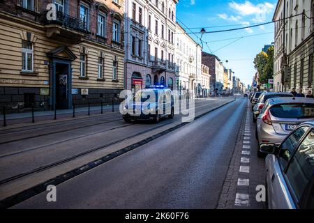 Krakow, Poland - October 08, 2022 Police car driving in the city center of Krakow in Poland Stock Photo