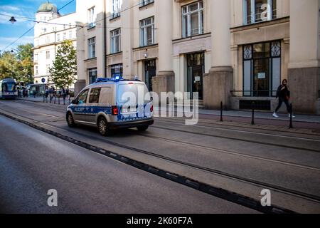 Krakow, Poland - October 08, 2022 Police car driving in the city center of Krakow in Poland Stock Photo