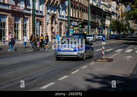 Krakow, Poland - October 08, 2022 Police car driving in the city center of Krakow in Poland Stock Photo