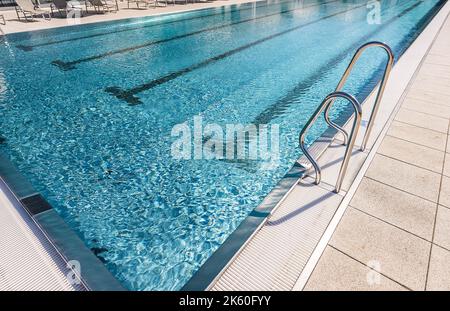 Ladder stainless handrails for descent into swimming pool Stock Photo