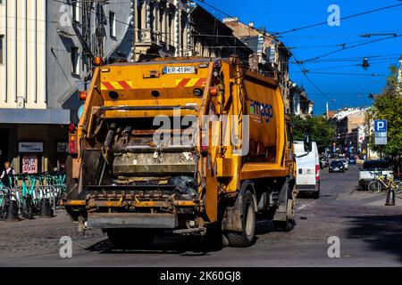 Krakow, Poland - October 08, 2022 Garbage truck driving in the city center of Krakow in Poland Stock Photo