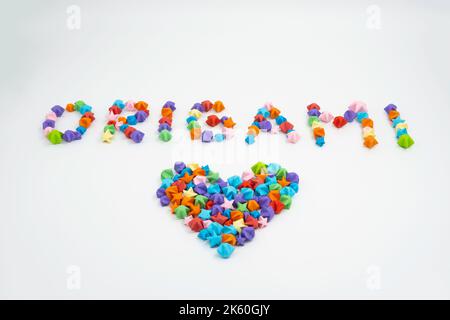 Origami sign and heart creative concept made of bunch of multi colored origami stars Stock Photo