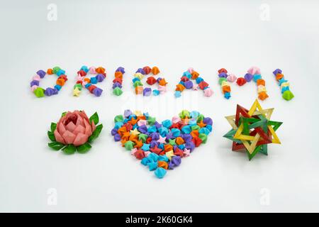 Origami sign and heart creative concept made of bunch of multi colored origami stars Stock Photo