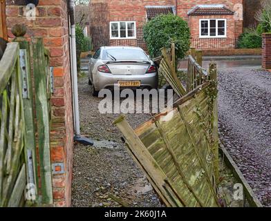 garden fence blown down on car after storm Arwen york yorkshire united kingdom Stock Photo