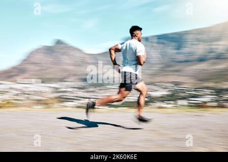 Athletic young mixed race man sprinting outdoors in nature. Fit handsome hispanic male athlete man out for a run. Fitness cardio and endurance Stock Photo