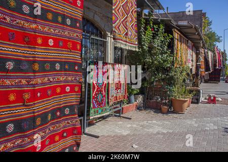 Hand weaving carpets, handmade rugs hanging in front of shops in Bergama Izmir Stock Photo