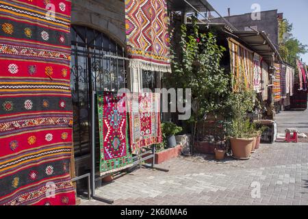 Handmade carpets, hand weawing rugs hanging in front of shops in Bergama Izmir Stock Photo
