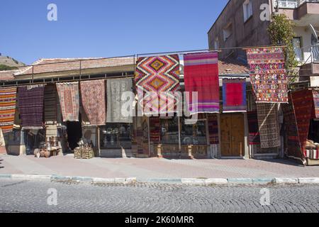 Handmade carpets, hand weaving rugs is hanging in front of the traditional carpet shop Stock Photo