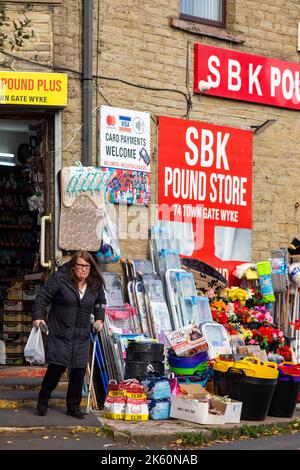 Families and women and old people use the Pound store and a discount store to shop in the town of Wyke situated within the City of Bradford boundaries. As the cost of living crisis bites and hits people on lower incomes more are turning to discount shops to save money.Credit: Windmill Images/Alamy Live News Stock Photo