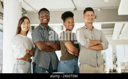 Portrait of successful creative business team looking at camera and smiling. Diverse business people standing together with their arms crossed at Stock Photo