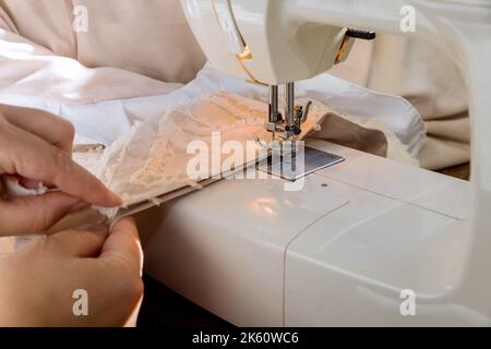 Workplace of tailor seamstress sews clothes on sewing machine Stock Photo