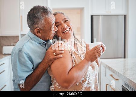 Love, laughing and elderly couple embrace in kitchen, having fun, talking and being silly together. Happy family, relax and retirement by senior man Stock Photo