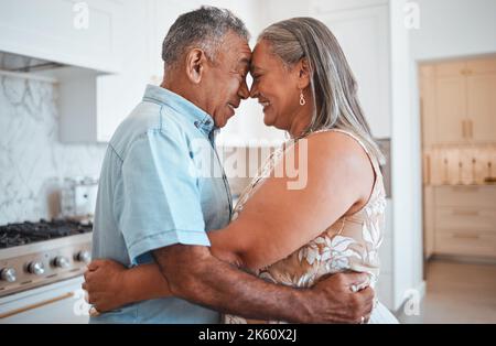 Hug, love and senior couple with smile for retirement, marriage or support in the kitchen of their house. Happy and elderly man and woman hugging on Stock Photo