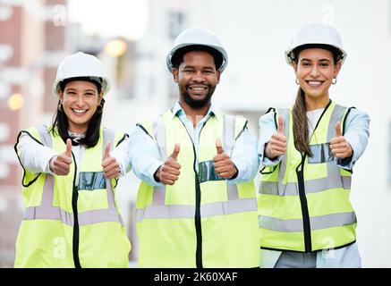 Thumbs up, success and construction employees in collaboration for building goal in city of New Zealand together. Portrait of team of engineer workers Stock Photo