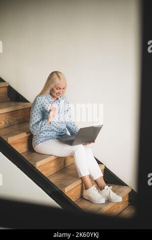 Joyous woman communicating with someone via Skype Stock Photo