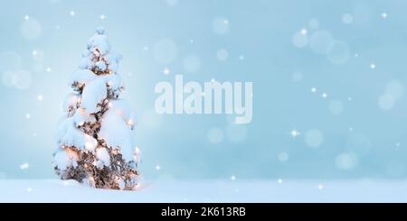 Snow covered tree with lights. Christmas and New Year background. Stock Photo