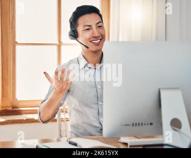 Call center, telemarketing and customer support consultant working on a computer in modern office. Happy, smile and asian man doing online Stock Photo