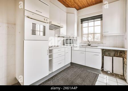Old fashioned cupboards in light kitchen of classic flat Stock Photo