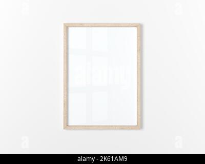 Blank frame. Poster mockup. Vertical wooden frame hanging on a white wall. Isolated. 3d illustration. Stock Photo