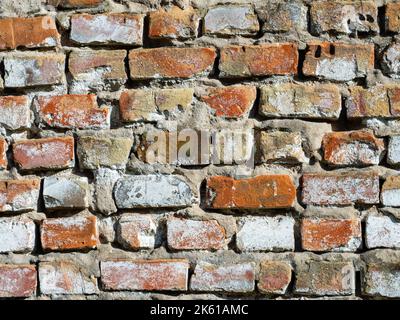 Old brick wall destroyed by time as background Stock Photo
