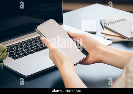 Close up of female hands using smartphone at office table Stock Photo