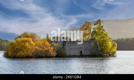 Loch an Eilein Aviemore Scotland the castle on an island in the loch surrounded by colourful trees and shrubs in autumn Stock Photo