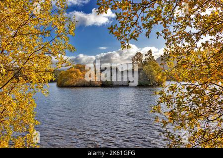 Loch an Eilein Aviemore Scotland trees with autumnal leaves frame the castle on a small island Stock Photo