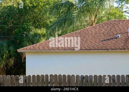 Closeup of house roof top covered with asphalt or bitumen shingles. Waterproofing of new building Stock Photo