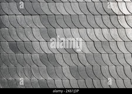 Detail close-up of natural grey stone shingle slate tiles texture roof abstract surface background. Natural mineral material dark rock plate building Stock Photo