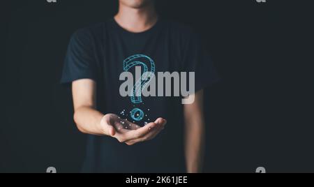 Question mark symbol with hologram on hand of man. Thinking Concept. Stock Photo