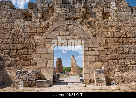 Ancient gate through the city walls into the ruins of Perge, ruins of the Roman city of Perge, Antalya, Turkey Stock Photo