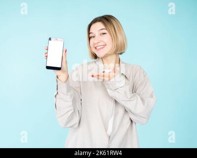 presenting product happy woman mobile app Stock Photo