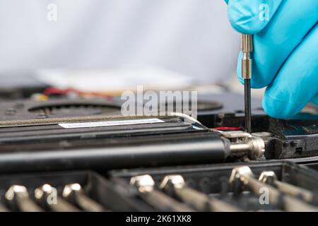 Hands of a technician repairing a broken laptop computer Stock Photo