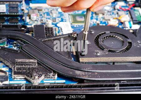 Man disassembles a laptop. Computer service and repair concept. Laptop disassembling in repair shop Stock Photo