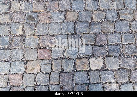 Old pavement of granite background. Top view on stone road close up. Stock Photo
