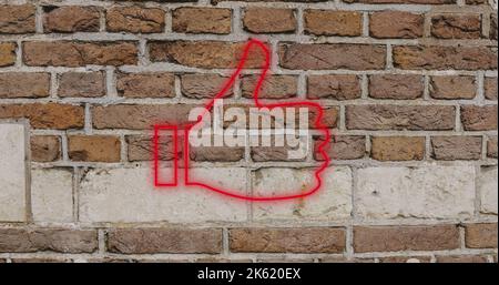 Composite of digital red like button icon against brick wall, copy space Stock Photo