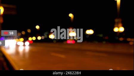Composite of message icon and 16 number over defocused road with illuminated street lights at night Stock Photo