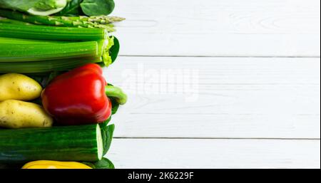 Directly above shot of various fresh raw vegetables arranged over wooden table, copy space Stock Photo