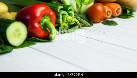 Close-up of fresh various raw vegetables arranged on wooden table, copy space Stock Photo