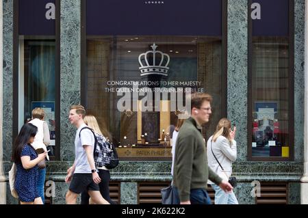 Platinum Jubilee decorations are seen drawn on the window of a retail unit in central London ahead of the Platinum Jubilee celebrations. Stock Photo