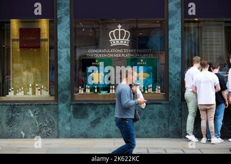 Platinum Jubilee decorations are seen drawn on the window of a retail unit in central London ahead of the Platinum Jubilee celebrations. Stock Photo